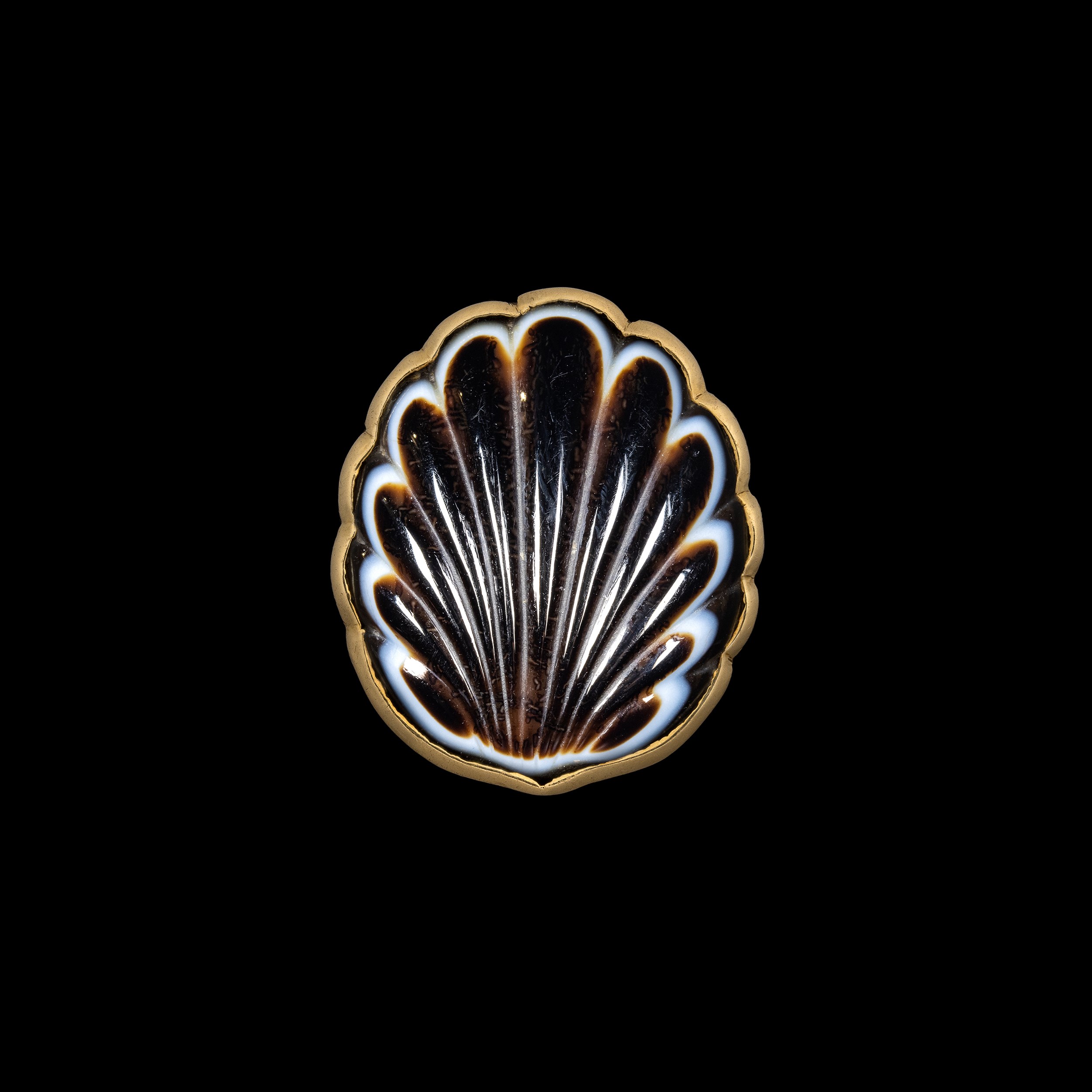 A Large Victorian gold ring set with a banded agate shell.